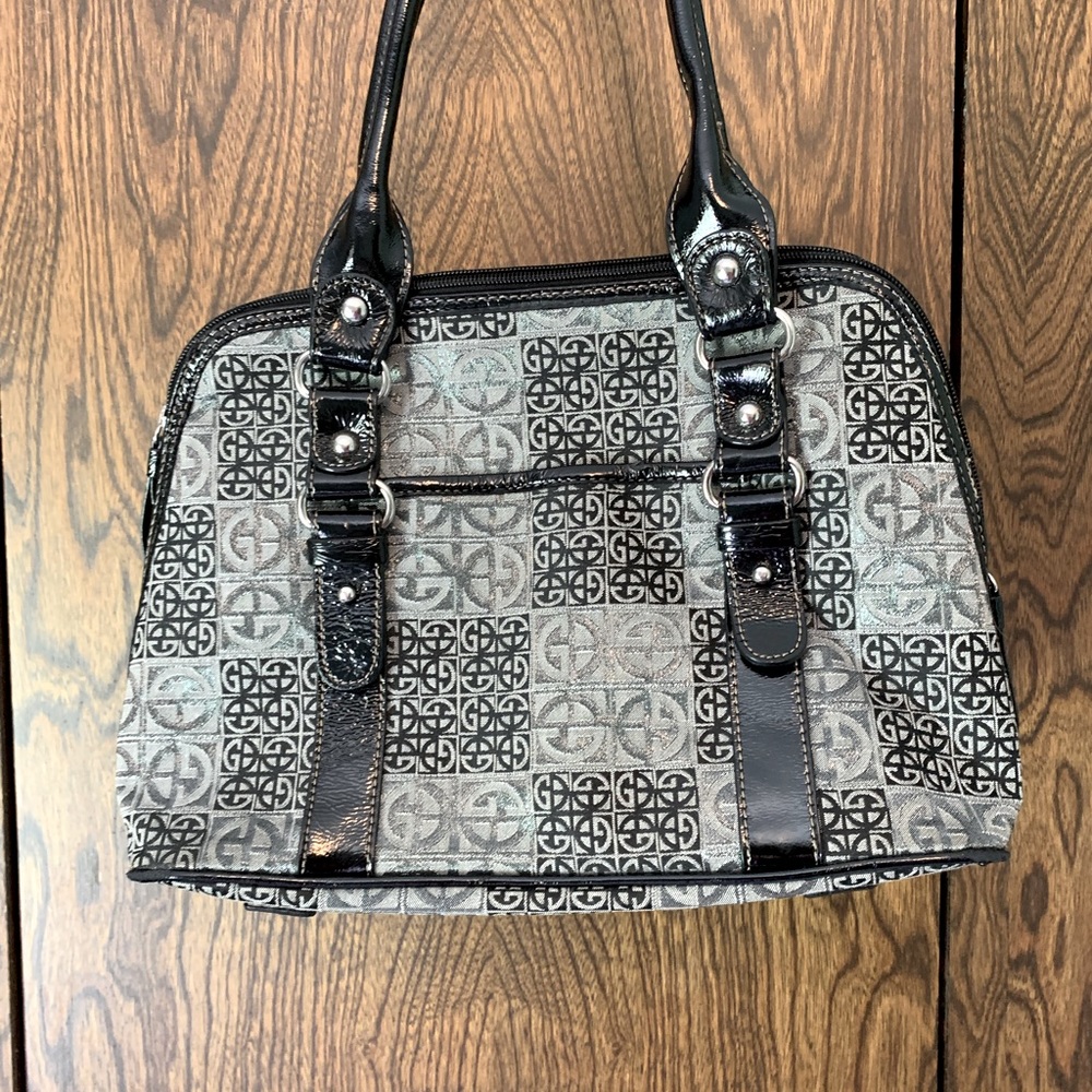 Midsize Handbag black and silver in color.
